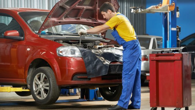 Mechanic fixing the car Mechanic fixing the car