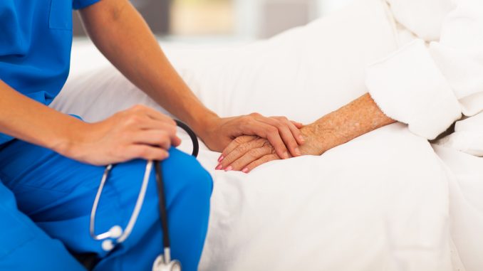 nurse holding a patient's hand nurse holding a patient's hand