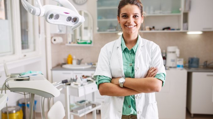 a dentist in her clinic a dentist in her clinic
