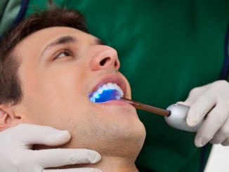 Man getting a checkup with a cosmetic dentist