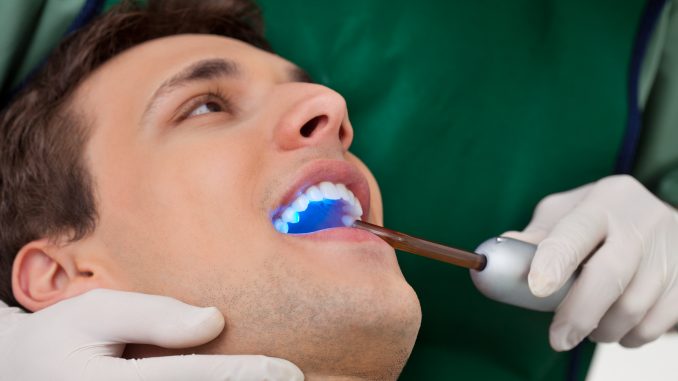 Man getting a checkup with a cosmetic dentist Man getting a checkup with a cosmetic dentist