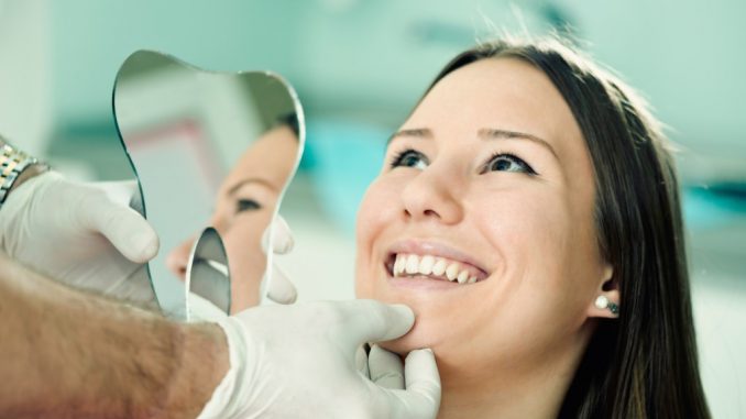 Woman smiling during a dental checkup Woman smiling during a dental checkup