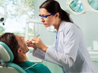 Man being checked by dentists