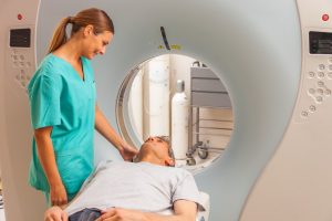 nurse preparing man for CT scan