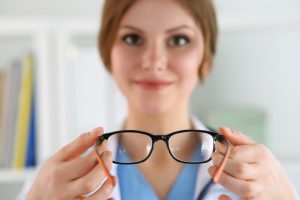 Optometrist handing eyeglasses