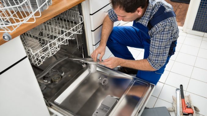 a man repairing the dishwasher a man repairing the dishwasher