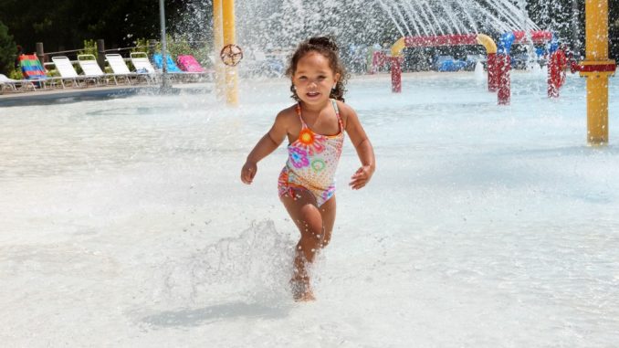 little girl playing at a water park little girl playing at a water park