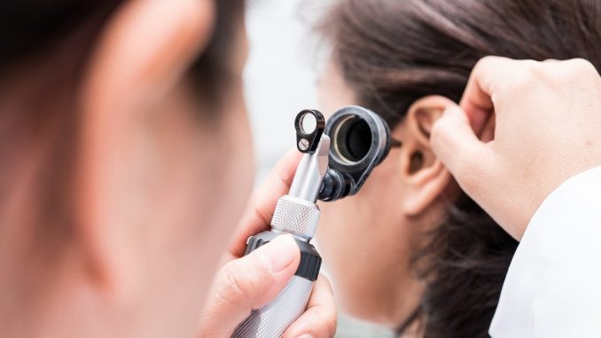 Doctor examining a patient's ear Doctor examining a patient's ear