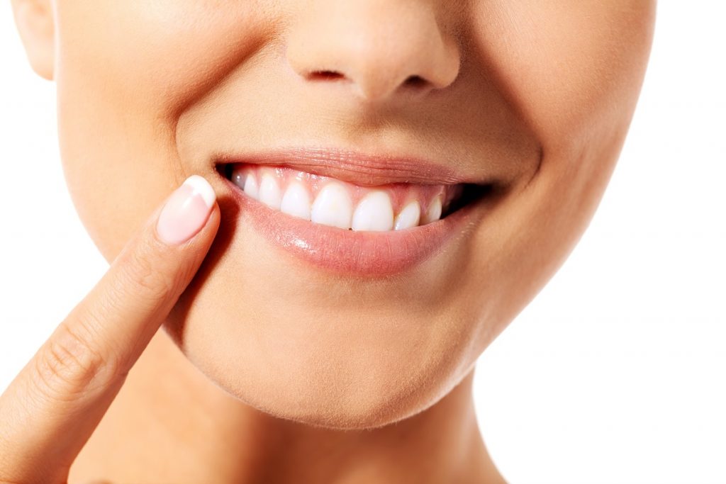 Woman pointing at her teeth