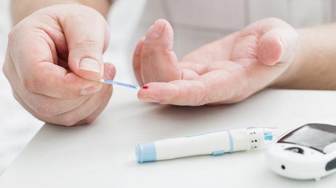 Person getting blood for sugar level check Person getting blood for sugar level check