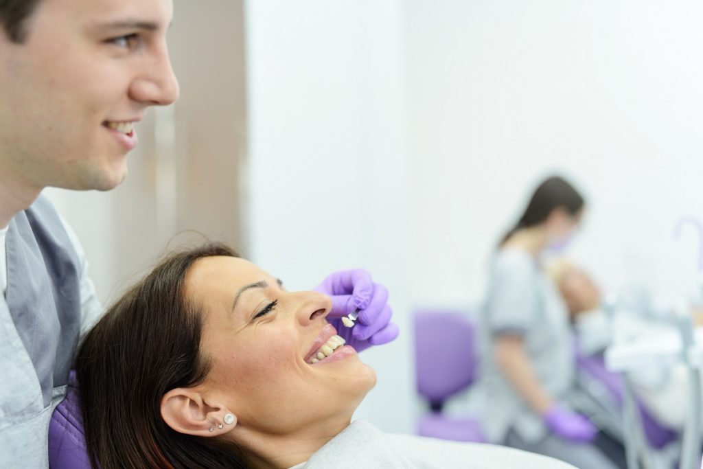 woman getting a veneer on for her teeth in the dental clinic
