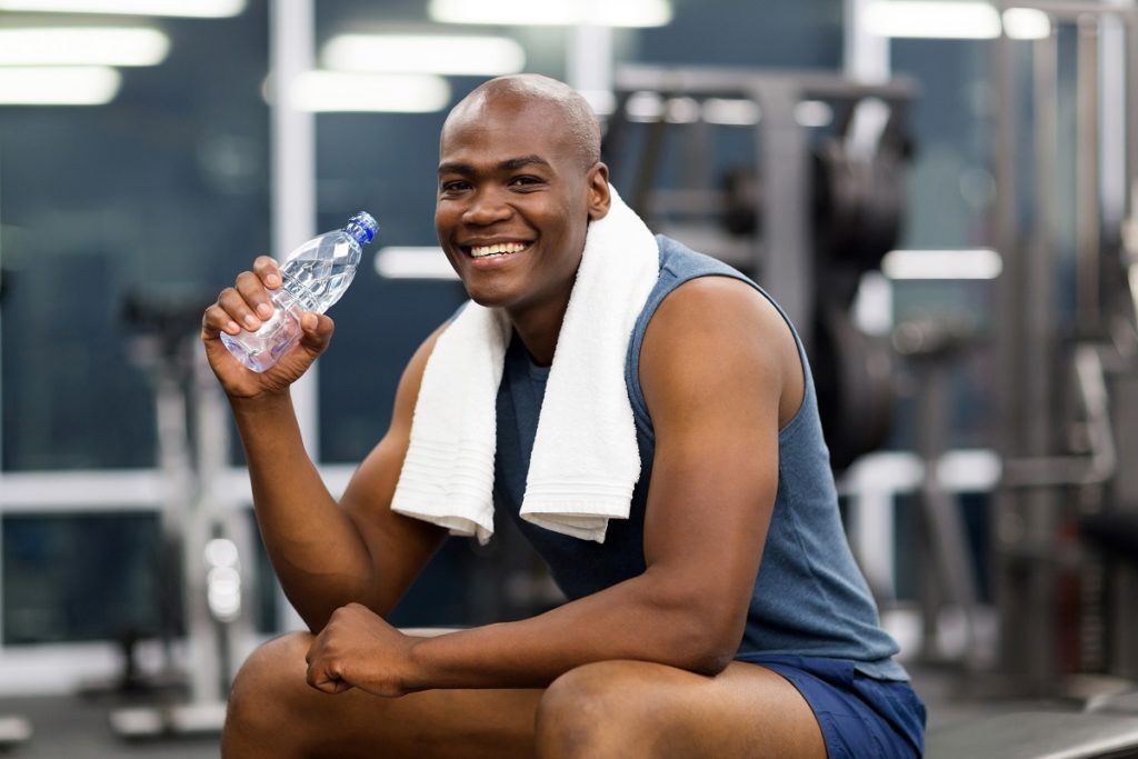 Man drinking water at the gym