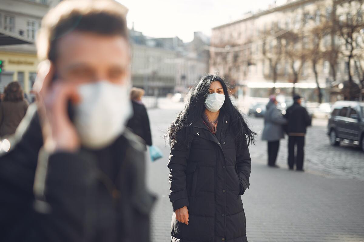 men and woman wearing masks while outside