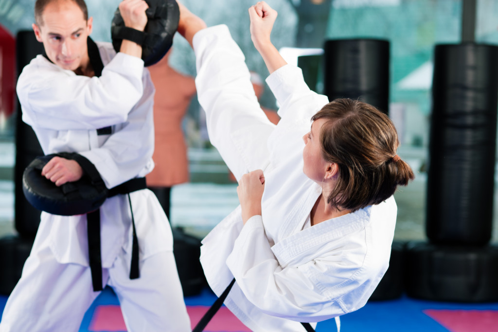 A woman performing taekwondo