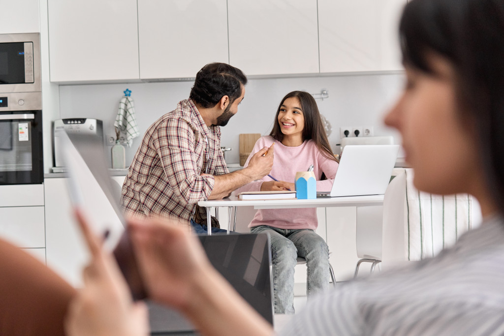 a mother sitting away while daughter and father are talking