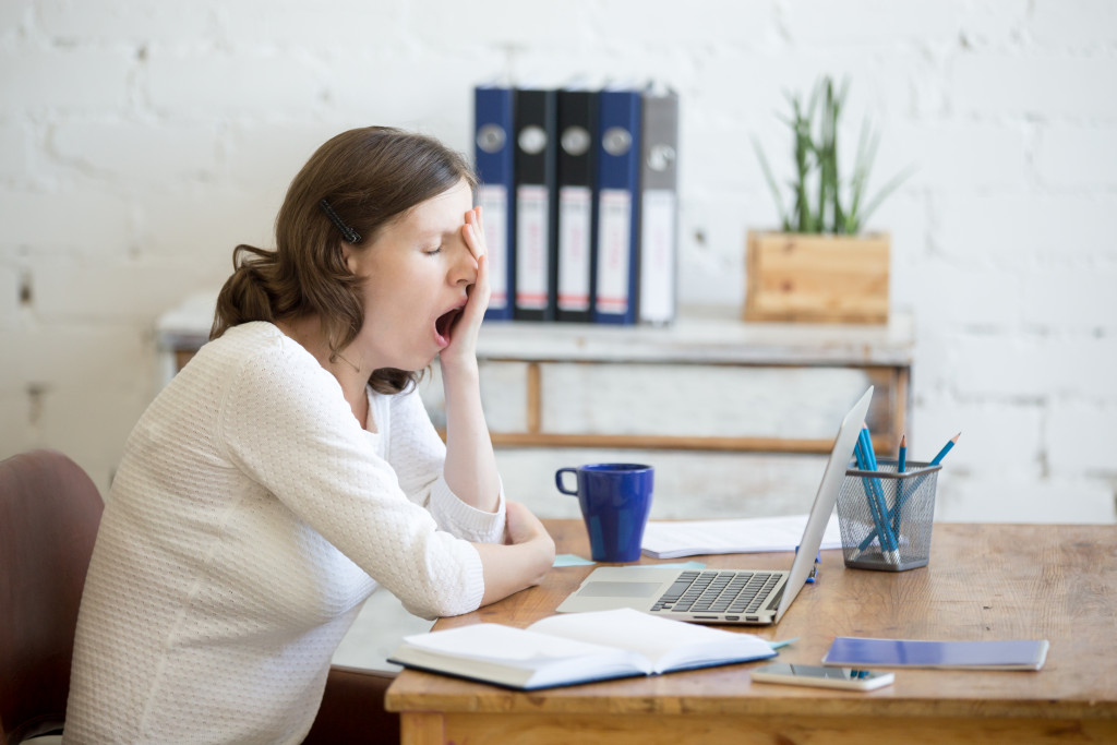 An employee yawning because of tiredness