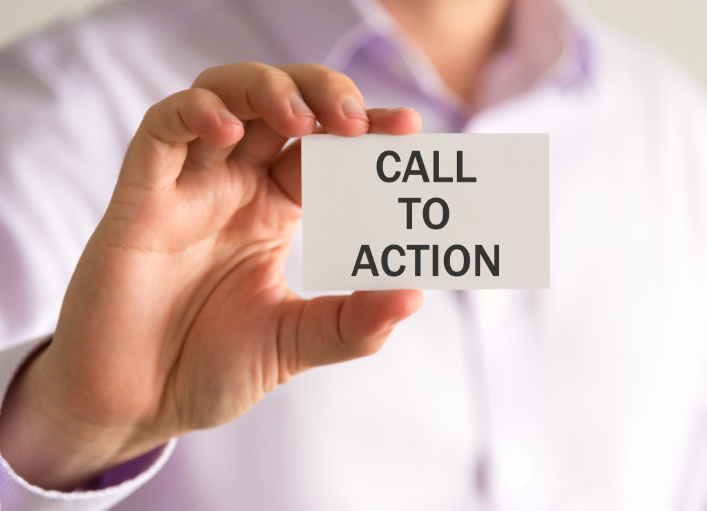 A person holding a card with the text Call to Action