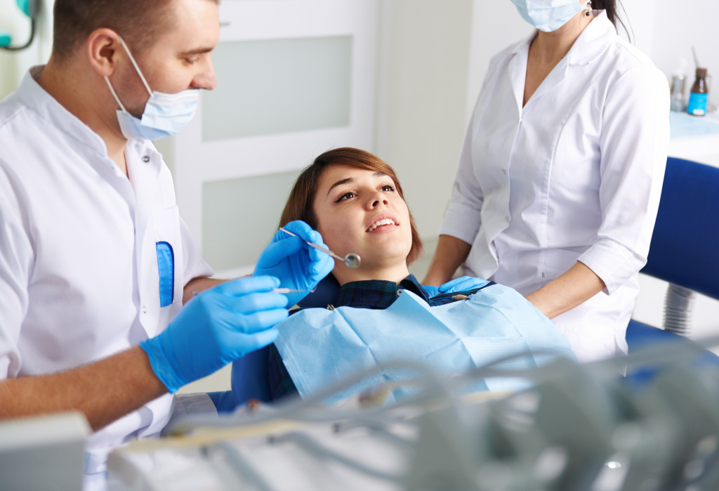 A dentist checking on a patient